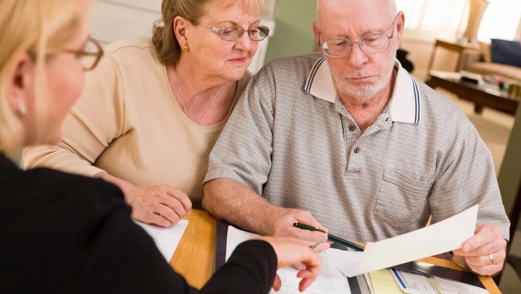Older Elderly Couple looking at Paperwork