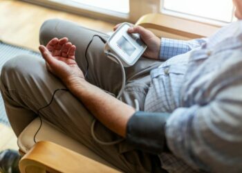 Older Elderly man checking his own blood sugar