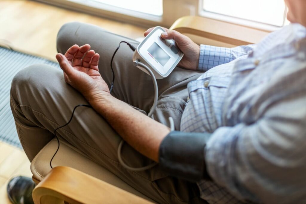 Older Elderly man checking his own blood sugar